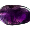 A closeup of a polished amethyst large stone, showing a deep purple hue and translucency to the stone.