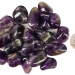 A pile of large amethyst tumbled stones with deep purple, to violet hues, and some white patterns, with a quarter for comparison. Some are smaller than the quarter, and some the samdiameter or larger.