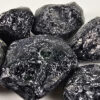 Apache tears that are polished, showing a deep black and white patterns through the stones.