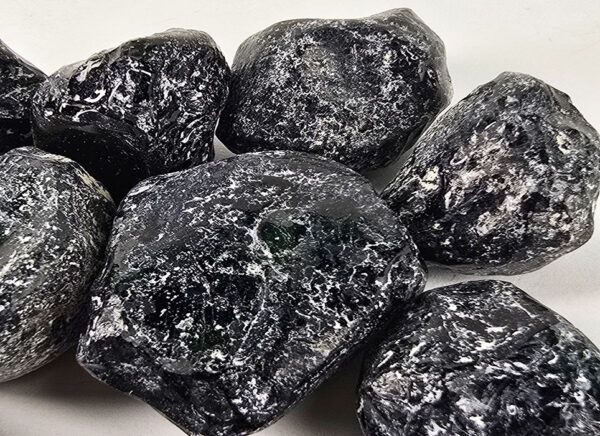 Apache tears that are polished, showing a deep black and white patterns through the stones.