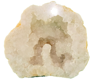A cut and polished Moroccan Geode half, reflecting light showing the quality of the polish. The inside of the geode is hollow, with many quartz crystals that are clear to milky.