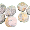 A pile of whole, unopened Trancas Geode, mostly grey, some black and brown, red on exterior.