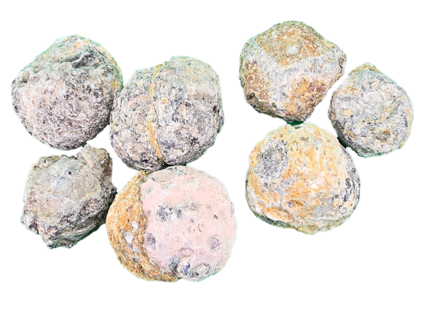 A pile of whole, unopened Trancas Geode, mostly grey, some black and brown, red on exterior.