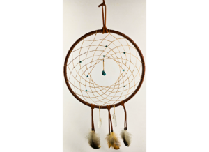 A large brown wrapped dream catcher with turquoise beads, and a turquoise chunk as the centerpiece, draped with feathers and quartz crystals.