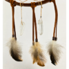 The bottom of a dream catcher that shows feathers held on by copper beads, with two quartz crystals hanging next to the feathers.