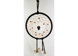 A black dream catcher with a chunk of tiger's eye as the centerpiece, with smaller stones woven around the center, and draped with feathers.