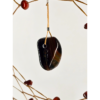 A closeup of a tiger's eye chunk hanging as the centerpiece of a dream catcher.