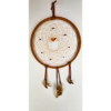 A light brown dream catcher with baltic amber as the centerpiece, surrounded by smaller brown stones woven in, draped with feathers.