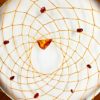 A closeup of baltic amber on the centerpiece of a dream catcher, surrounded by smaller brown stones.