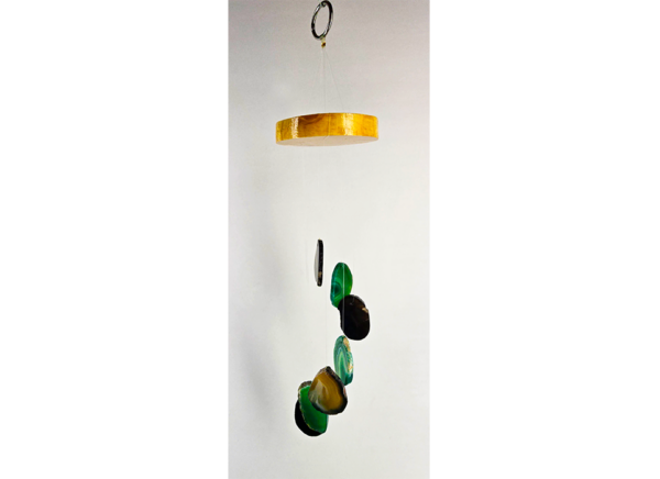 An agate windchime with a polished wood base strung with black and green agate slices.