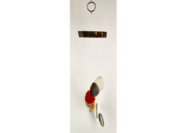 An agate windchime with a natural stained wood base, and a variety of colorful agate slices hanging from it.