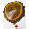 An agate windchime displaying the Cottonwood base that is polished and shows the rings in the wood, and a shiny finish.