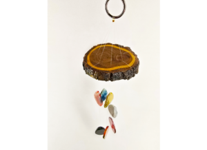 A multicolored agate windchime with a stained cottonwood base.