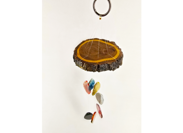 A multicolored agate windchime with a stained cottonwood base.