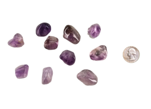 Small tumbled amethyst stone with rich purple hues, displayed beside a quarter, it's approximately the size of a quarter.
