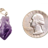 A closeup of an amethyst point pendant with a quarter for comparison. The stone is smaller than the quarter.