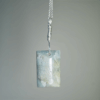 Aquamarine pendant with light blue, creamy yellowish white flowing through the polished stone, with a wire-wrapped silver bail.