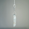 Side shot of aquamarine pendant with silver wire-wrapped bail.