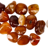 A pile of tumbled carnelian medium, with different shades of a brown honey color with some tranclucency to the polished stones, and a quarter for comparison. Most are the same size or larger than the quarter.