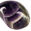 A closeup of medium chevron amethyst polished stone, with deep purple to violet, with white in chevron patterns on the stone.