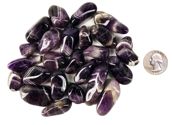 A pile of medium chevron amethyst polished stones, with deep purple to violet, with white in chevron patterns on the stones, and a quarter for comparison. Most are smaller than the quarter.