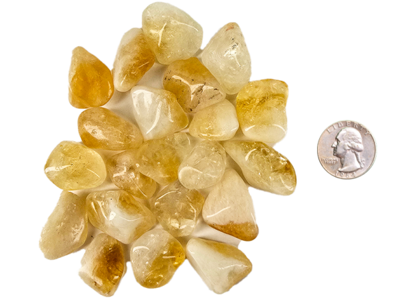 A pile of small tumbled citrine, with a light hone color, with some milky white, and translucency to the stones, with a quarter for comparison. All are slightly smaller than the quarter.