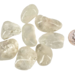 A pile of large quartz tumbled stones, that are mostly transparent with some inclusions, with a quarter for comparison. All are larger than the quarter.