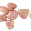 A pile of rose quartz stones large with deep pink hues with a quarter for comparison. All stones are larger than the quarter, about 1.5 times.