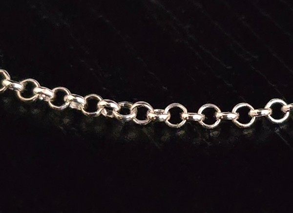 A closeup of the rolo chain on the sterling silver adjustable necklace.