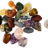A pile of tumbled mix with a range of small stones with a quarter for comparison. Most are slightly smaller than the quarter.