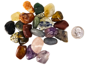 A pile of tumbled mix with a range of small stones with a quarter for comparison. Most are slightly smaller than the quarter.