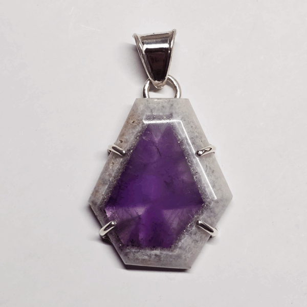 Atomic amethyst pendant with sterling silver posts securing stone, and a bail.