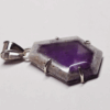 Atomic amethyst pendant with sterling silver posts securing stone, and a bail.