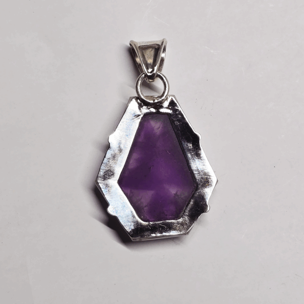 Back of atomic amethyst pendant with sterling silver backing, and a bail.