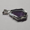Back of atomic amethyst pendant with sterling silver backing, and a bail.