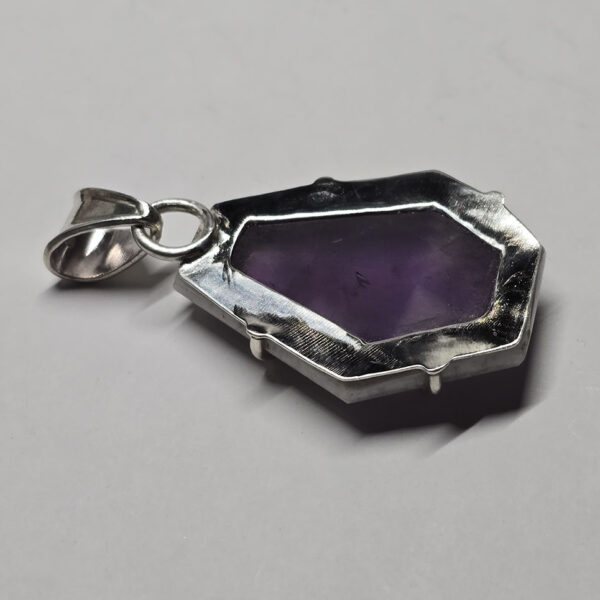 Back of atomic amethyst pendant with sterling silver backing, and a bail.