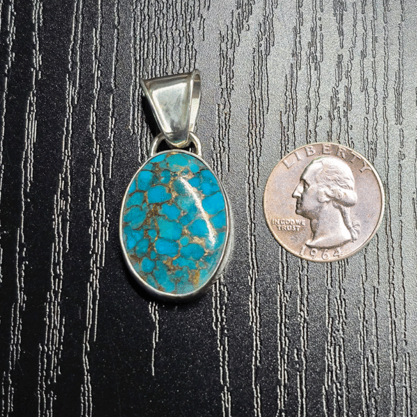 Sterling silver turquoise pendant with copper matrix with a quarter for comparison.